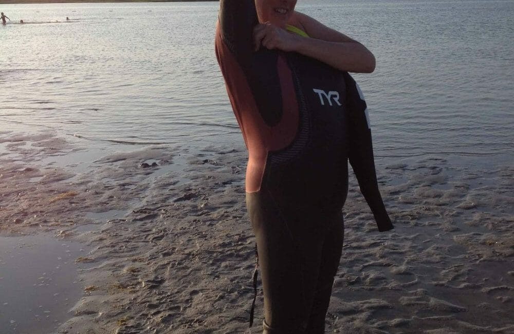 Hilary attempts to get on her wetsuit