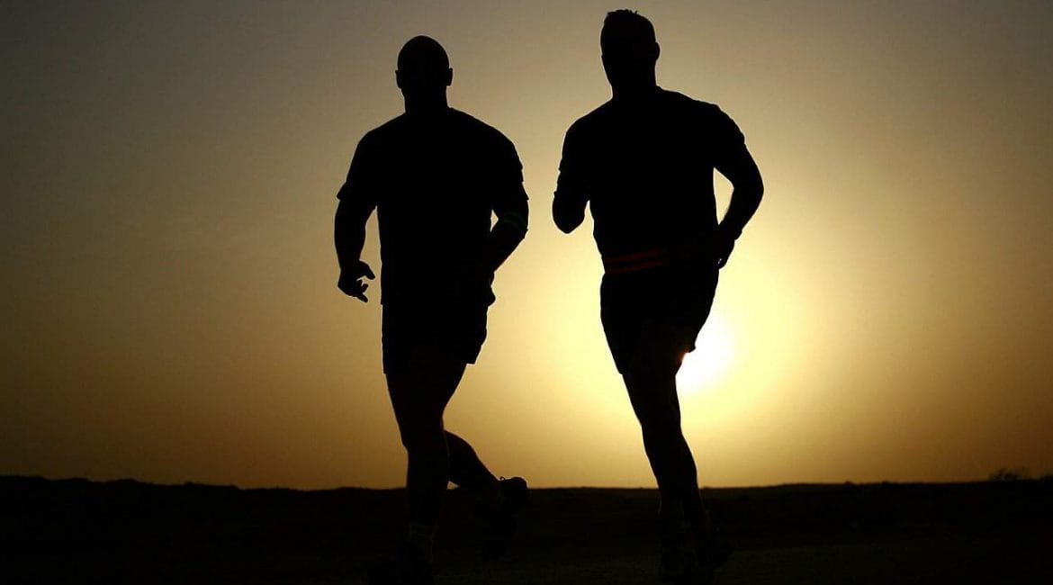 two men running as sun sets