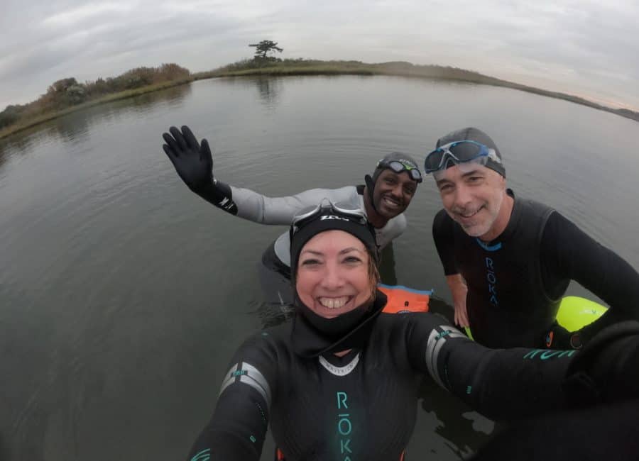 In November, three swimmers are still swimming open water