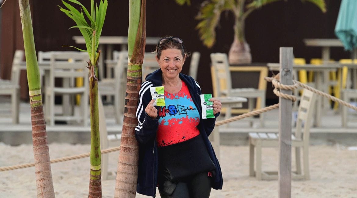 Hilary Topper holding Gu Energy Chews after a swim